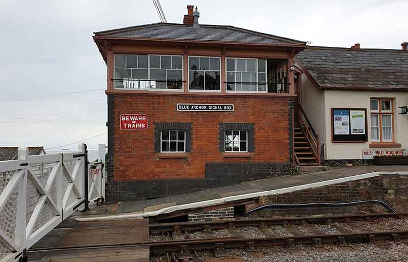 The rad brick signal box by the level crossing.